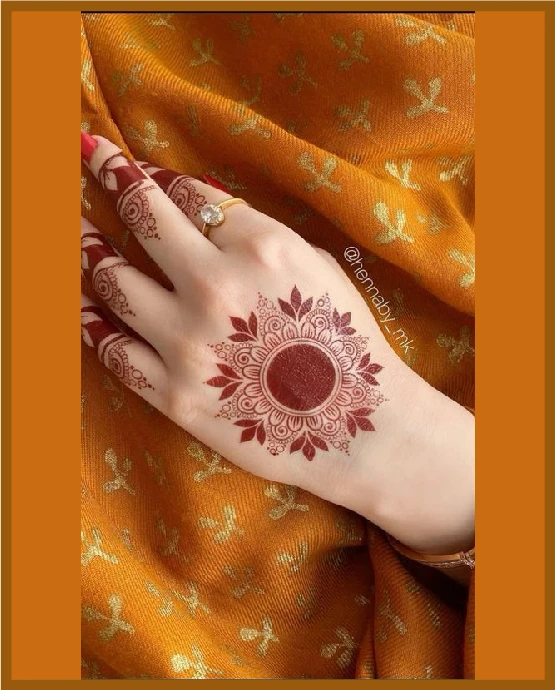 Khafif back hand mehndi with circular mandala centerpiece