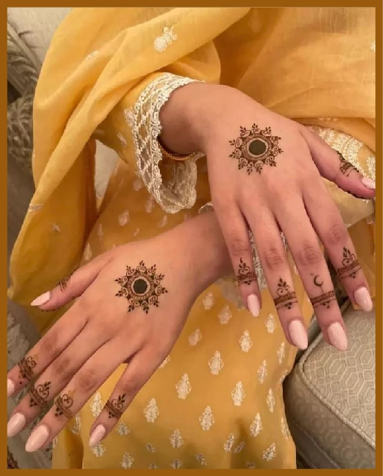 Khafif mehndi on back hand with circular mandala centerpiece