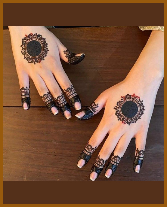 Simple back hand mehndi design with classic mandala center Simple back hand mehndi design with classic mandala center