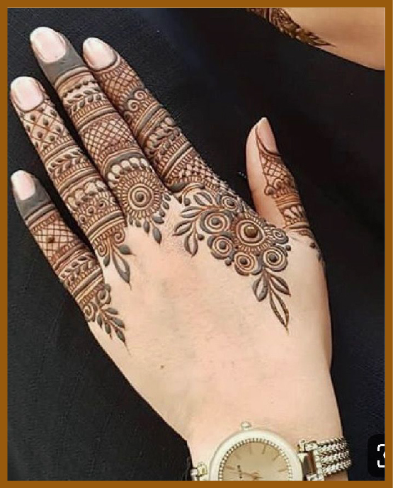 Simple back hand mehndi with finger net highlights Simple back hand mehndi with finger net highlights