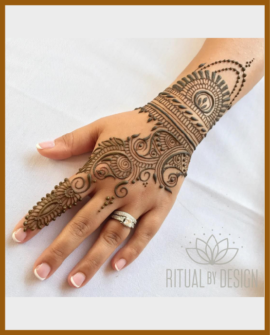 Stylish back hand mehndi design extended till wrist Stylish back hand mehndi design extended till wrist