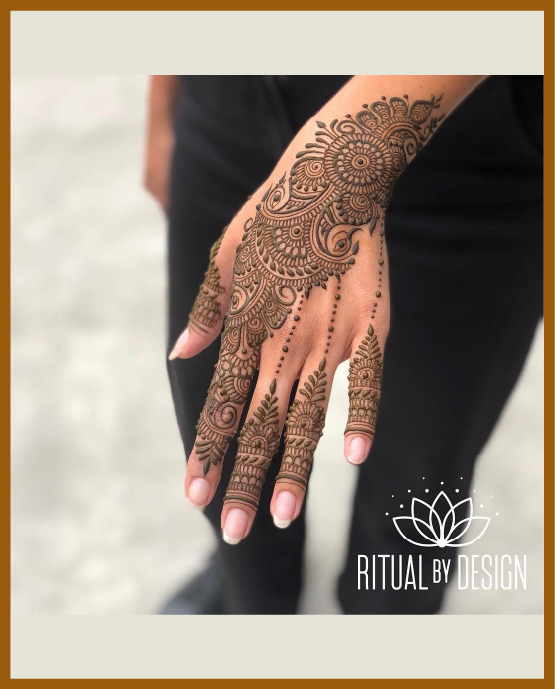 Stylish back hand mehndi design with leafy pattern and petals Stylish back hand mehndi design with leafy pattern and petals
