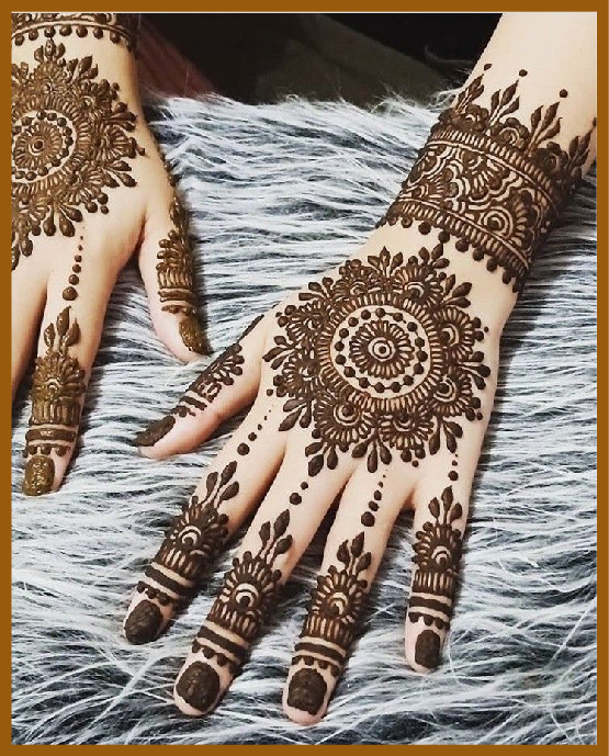 Stylish back hand mehndi wrist design with circular mandala Stylish back hand mehndi wrist design with circular mandala