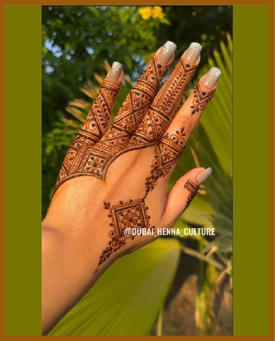 Aesthetic back hand mehndi design with small triangle blocks Aesthetic back hand mehndi design with small triangle blocks