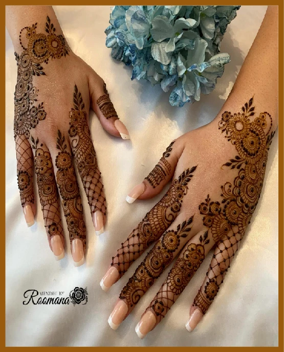 Aesthetic back hand mehndi with finger cuff details Aesthetic back hand mehndi with finger cuff details