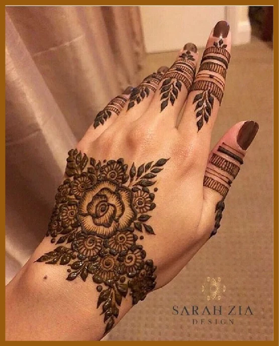 Aesthetic back hand mehndi with large center flower Aesthetic back hand mehndi with large center flower