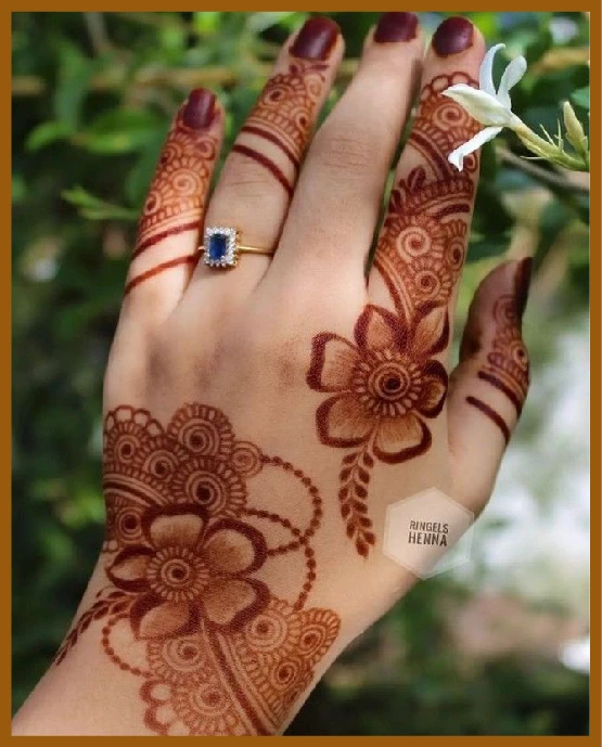 Aesthetic back hand mehndi with leafy detailing Aesthetic back hand mehndi with leafy detailing