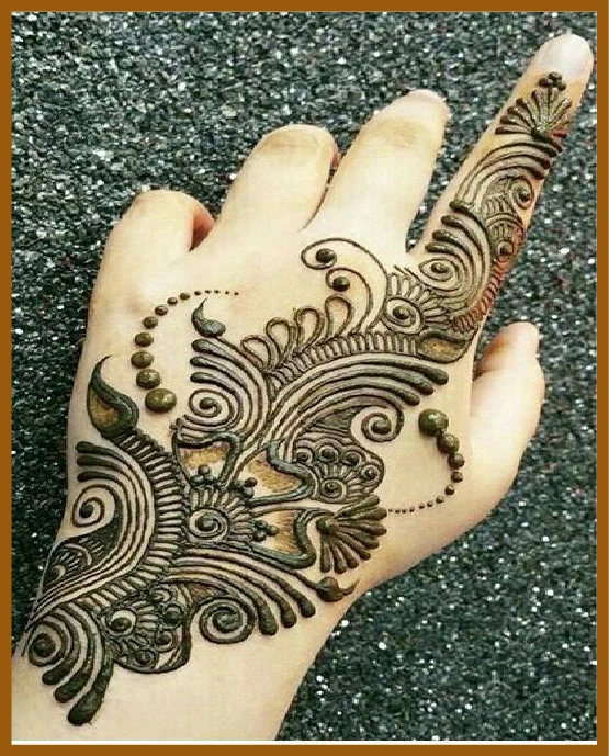 Aesthetic back hand mehndi with leafy trail Aesthetic back hand mehndi with leafy trail