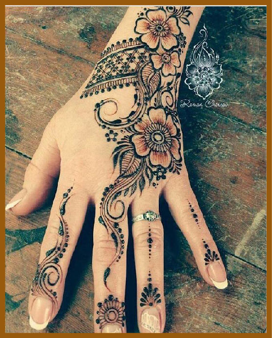 Delicate aesthetic back hand mehndi with thin outlines and loops Delicate aesthetic back hand mehndi with thin outlines and loops