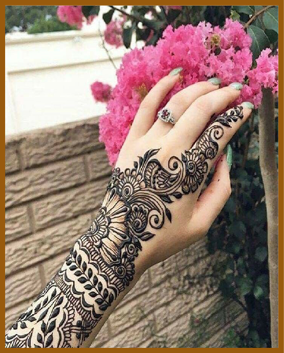 Elegant back hand mehndi design with leaf vines Elegant back hand mehndi design with leaf vines
