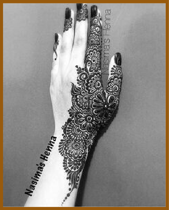 Grid-style aesthetic back hand mehndi with filled motifs Grid-style aesthetic back hand mehndi with filled motifs