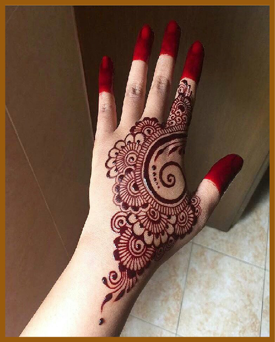 Symmetrical back hand mehndi with bold outlines Symmetrical back hand mehndi with bold outlines