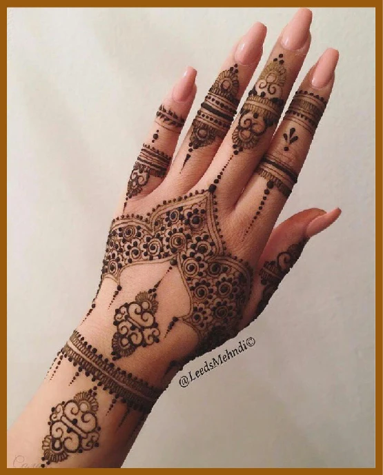 Crown style modern back hand mehndi design Crown style modern back hand mehndi design
