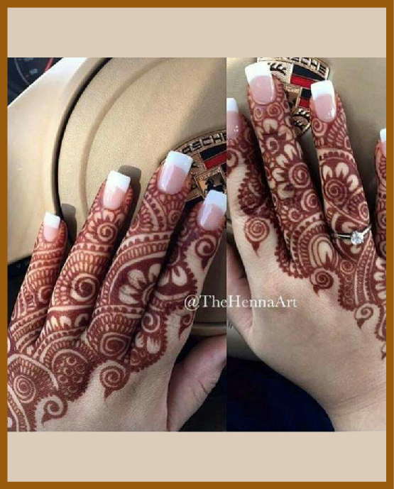 Neat lined fingers in modern back hand mehndi design Neat lined fingers in modern back hand mehndi design