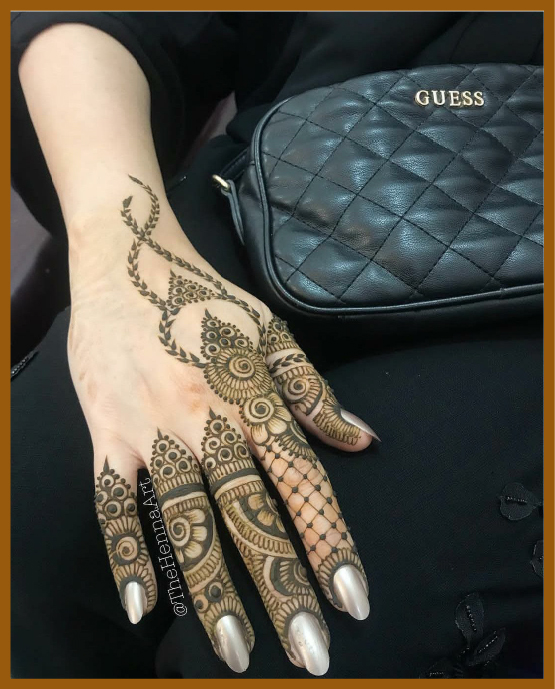 Spiral finger rings in modern back hand mehndi design Spiral finger rings in modern back hand mehndi design