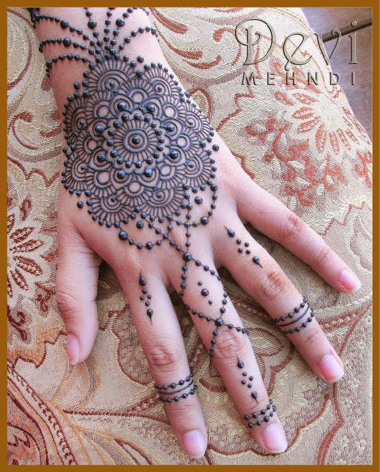 Twisted lines and dots in modern back hand mehndi design Twisted lines and dots in modern back hand mehndi design