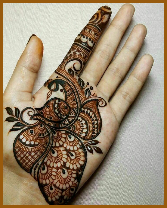 Peacock floral feather in minimal front hand mehndi design Peacock floral feather in minimal front hand mehndi design