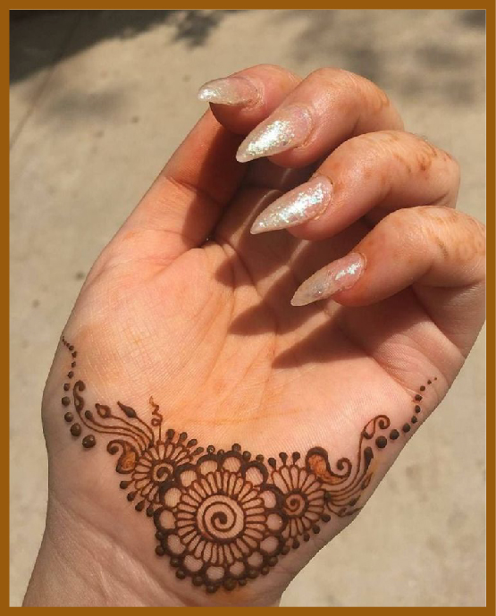 Wrist-only minimal front hand mehndi design with petals Wrist-only minimal front hand mehndi design with petals
